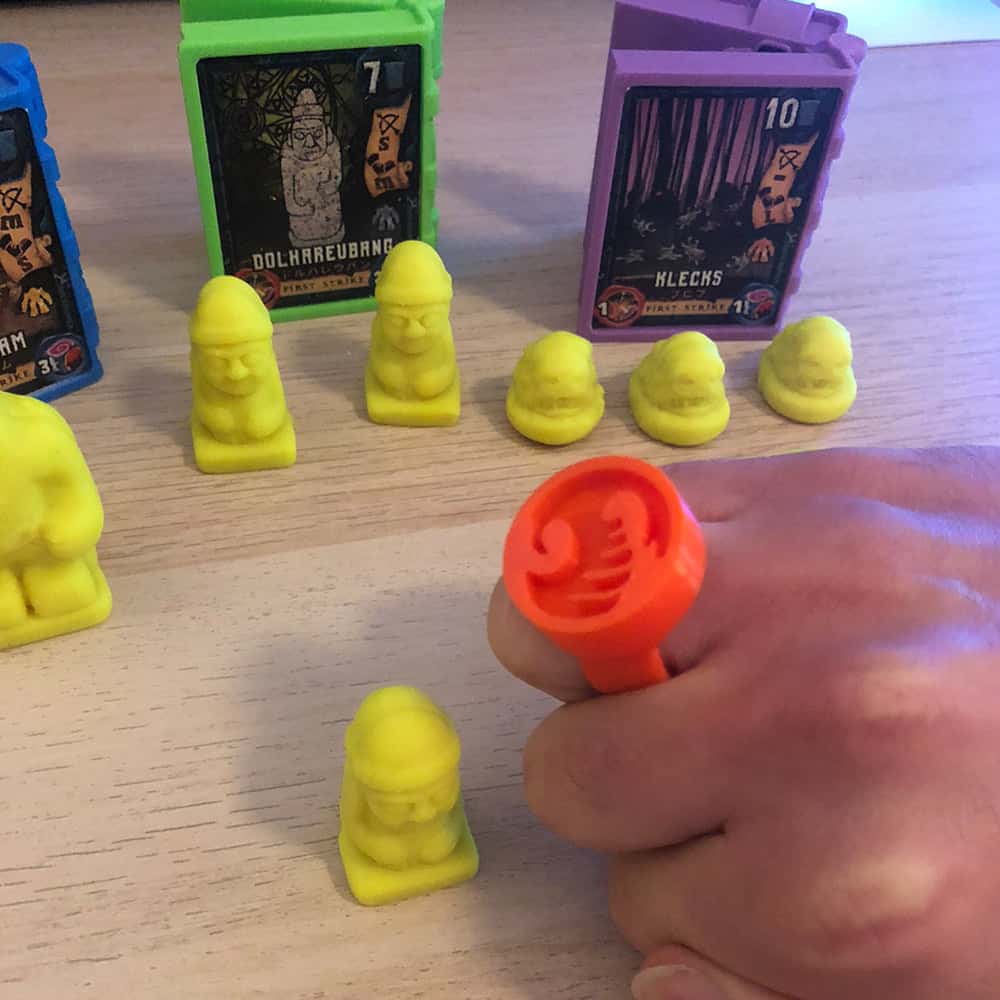3D printed prototype of the Necromolds Spellbook and Caster Ring toys used to mold and squish play doh like clay minis in the board game Necromolds.