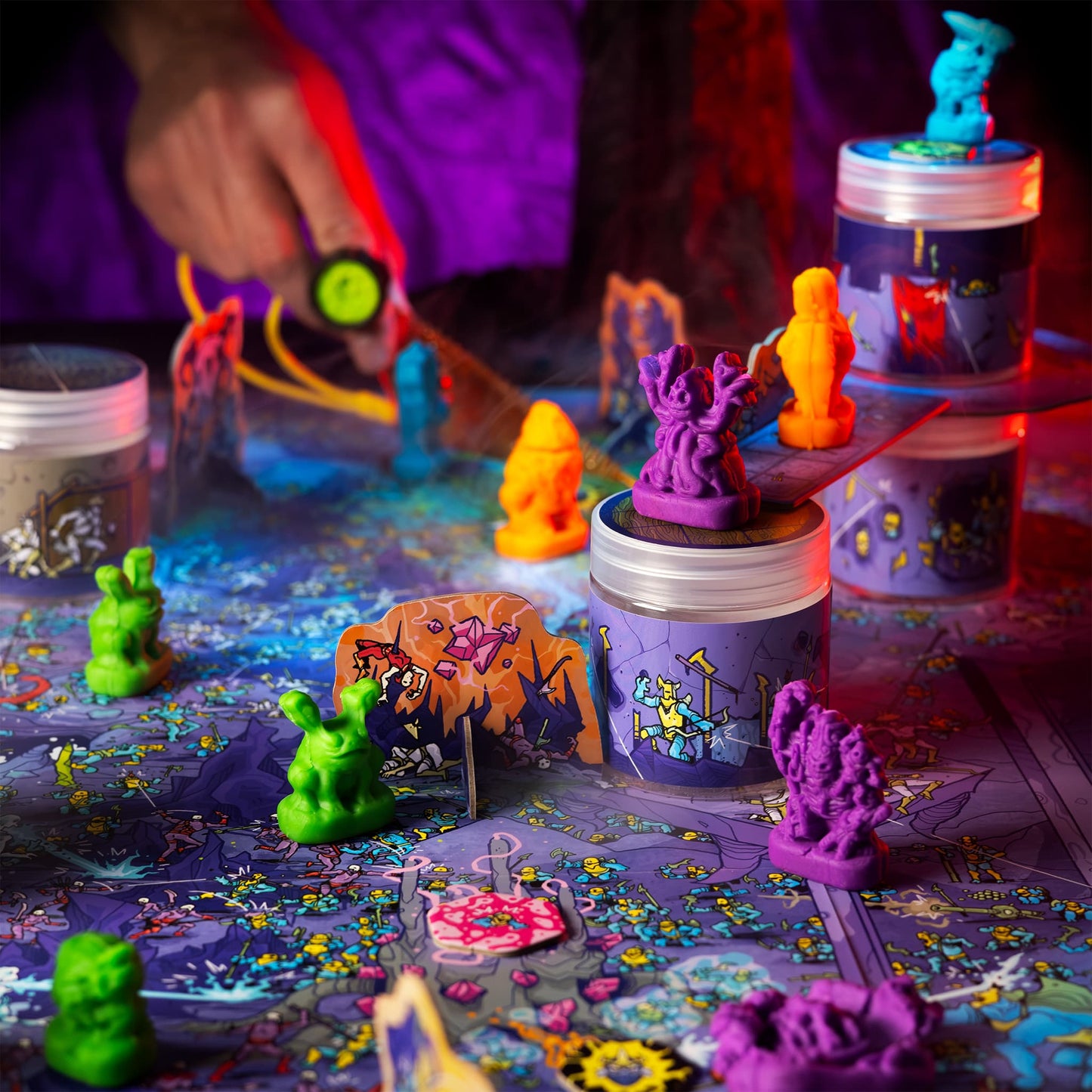 
                  
                    Colorful clay monster miniatures battling on an illustrated wargame map
                  
                