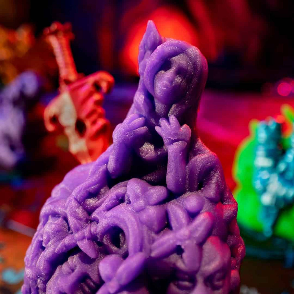 Close up of the highly detailed monster miniature molded out of purple play doh like clay.