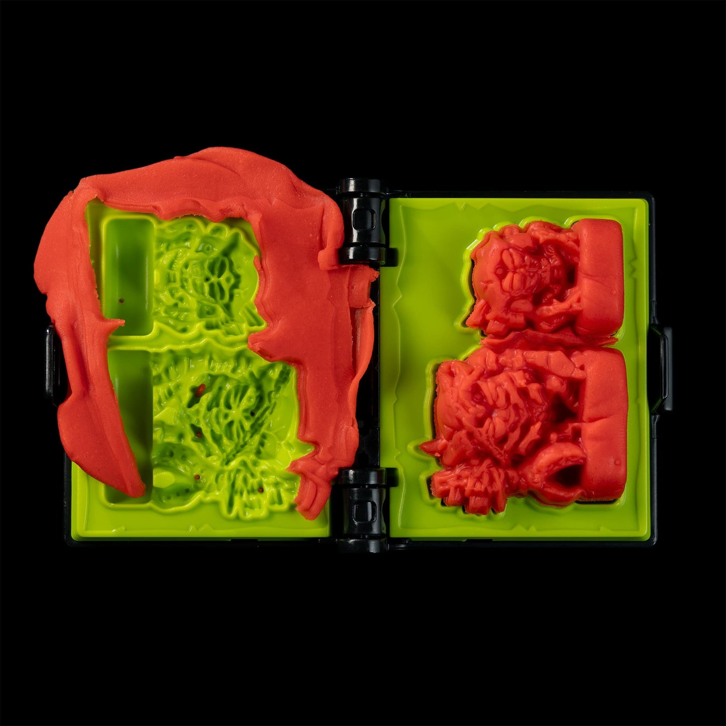 
                  
                    A spellbook shaped clay mold toy used in the Necromolds wargame to mold clay minis in the shape of creepy monsters. The clay is similar to red play doh.
                  
                