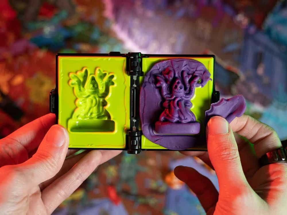 A aquatic lovecraft inspired sea monster miniature molded out of play doh like modeling clay in a spellbook toy mold for kids and adults.