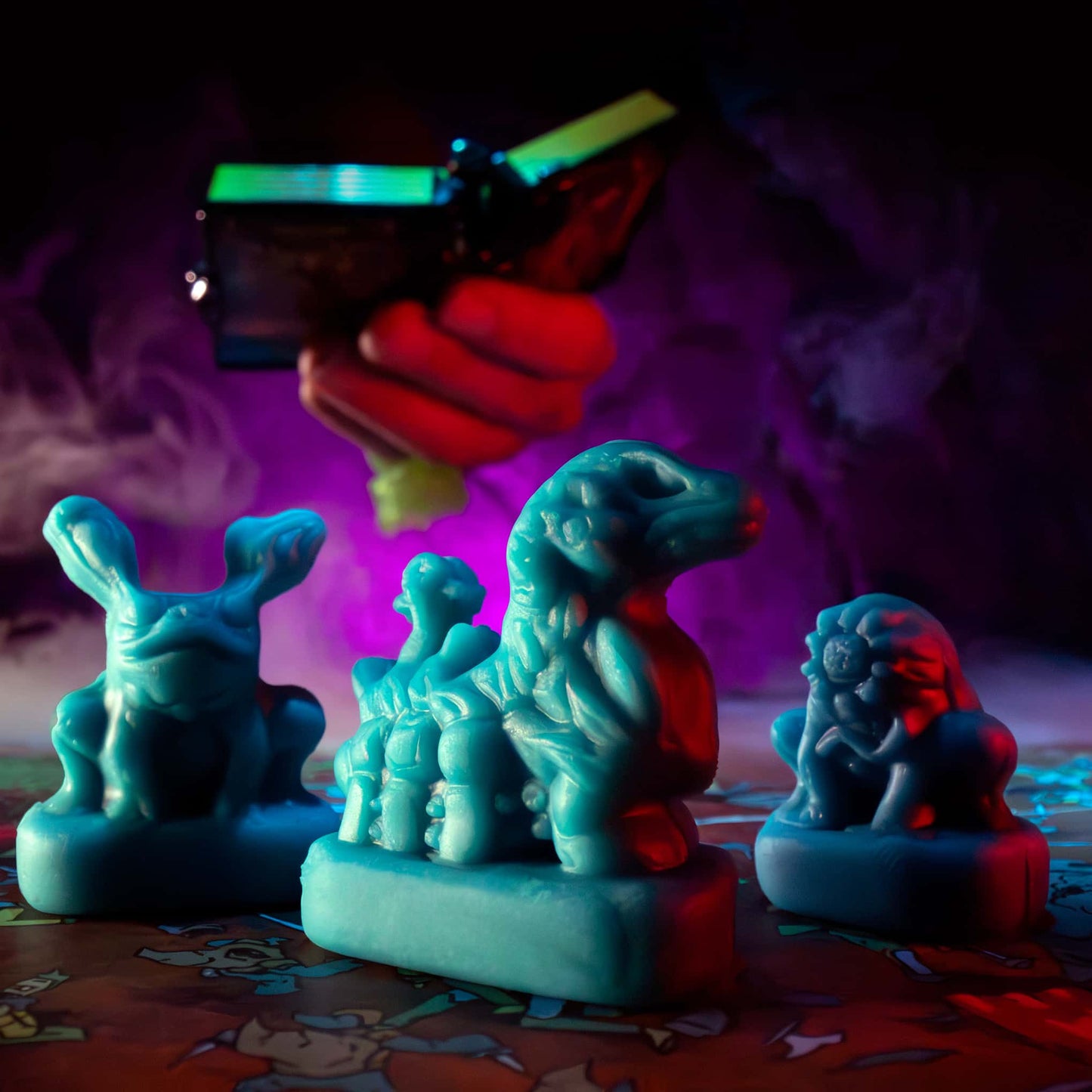 
                  
                    Three clay minis in the shape of creepy monsters that were molded from clay molds. The clay is similar to blue play doh. The minis are used in the Necromolds wargame.
                  
                