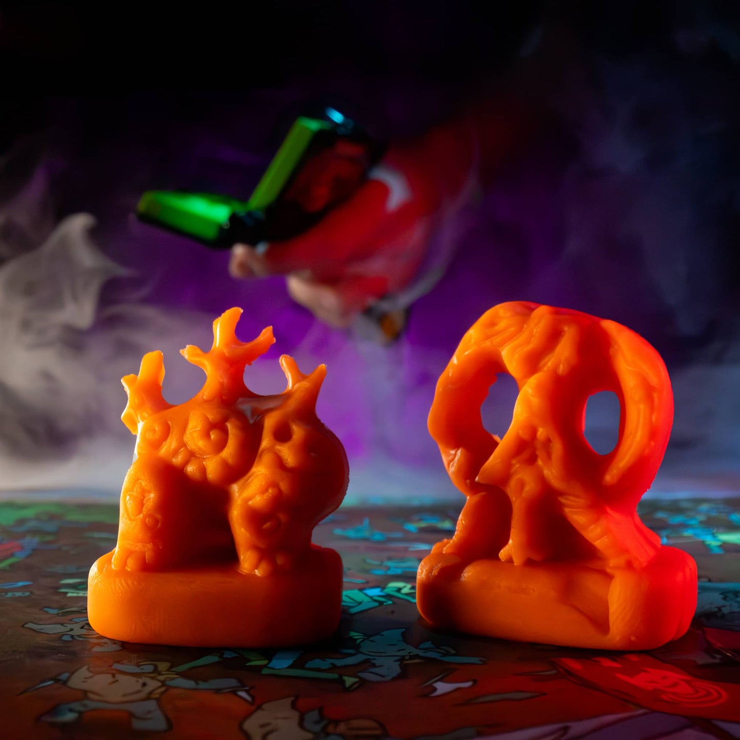 
                  
                    Two clay minis in the shape of creepy monsters that were molded from clay molds. The clay is similar to orange play doh. The minis are used in the Necromolds wargame.
                  
                