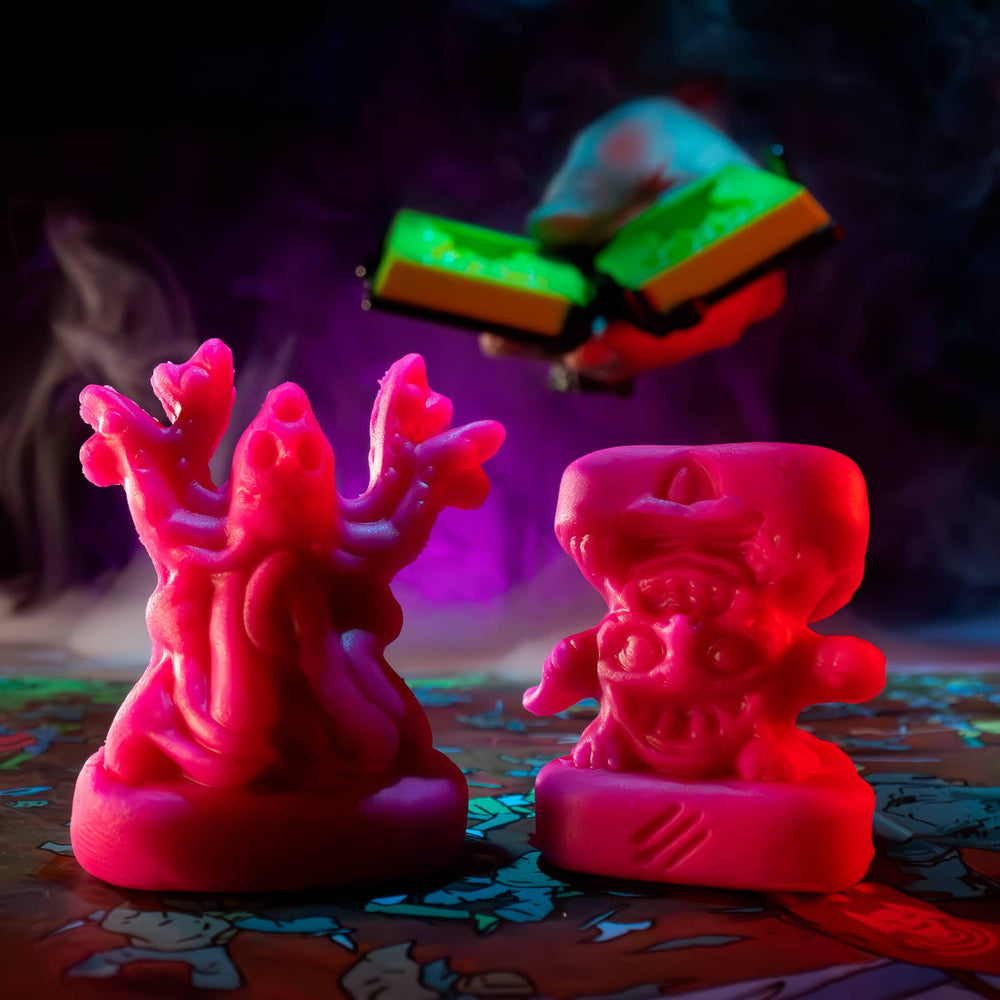 
                  
                    Two clay minis in the shape of creepy monsters that were molded from clay molds. The clay is similar to pink play doh. The minis are used in the Necromolds wargame.
                  
                