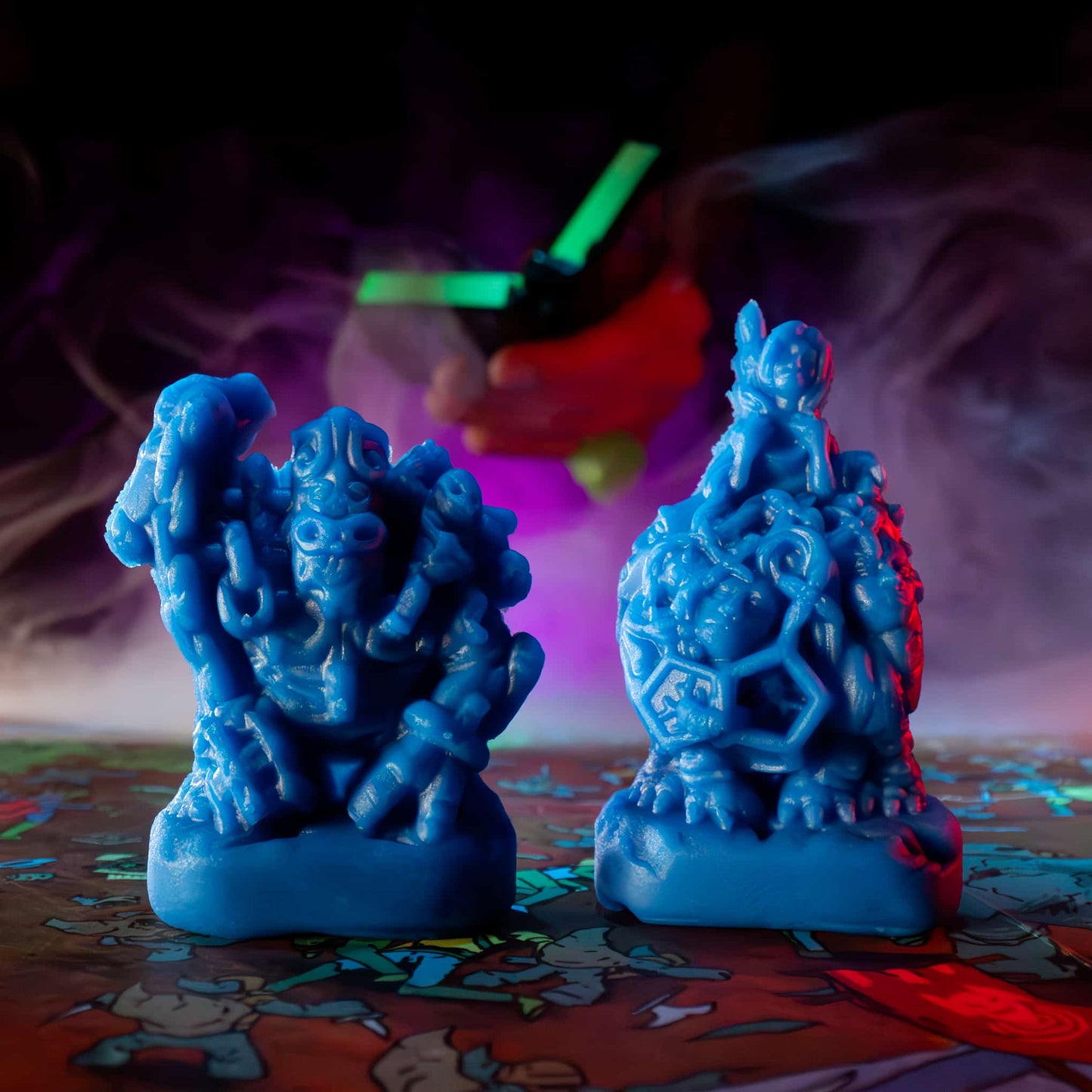 
                  
                    Two clay minis in the shape of creepy monsters that were molded from clay molds. The clay is similar to blue play doh. The minis are used in the Necromolds wargame.
                  
                