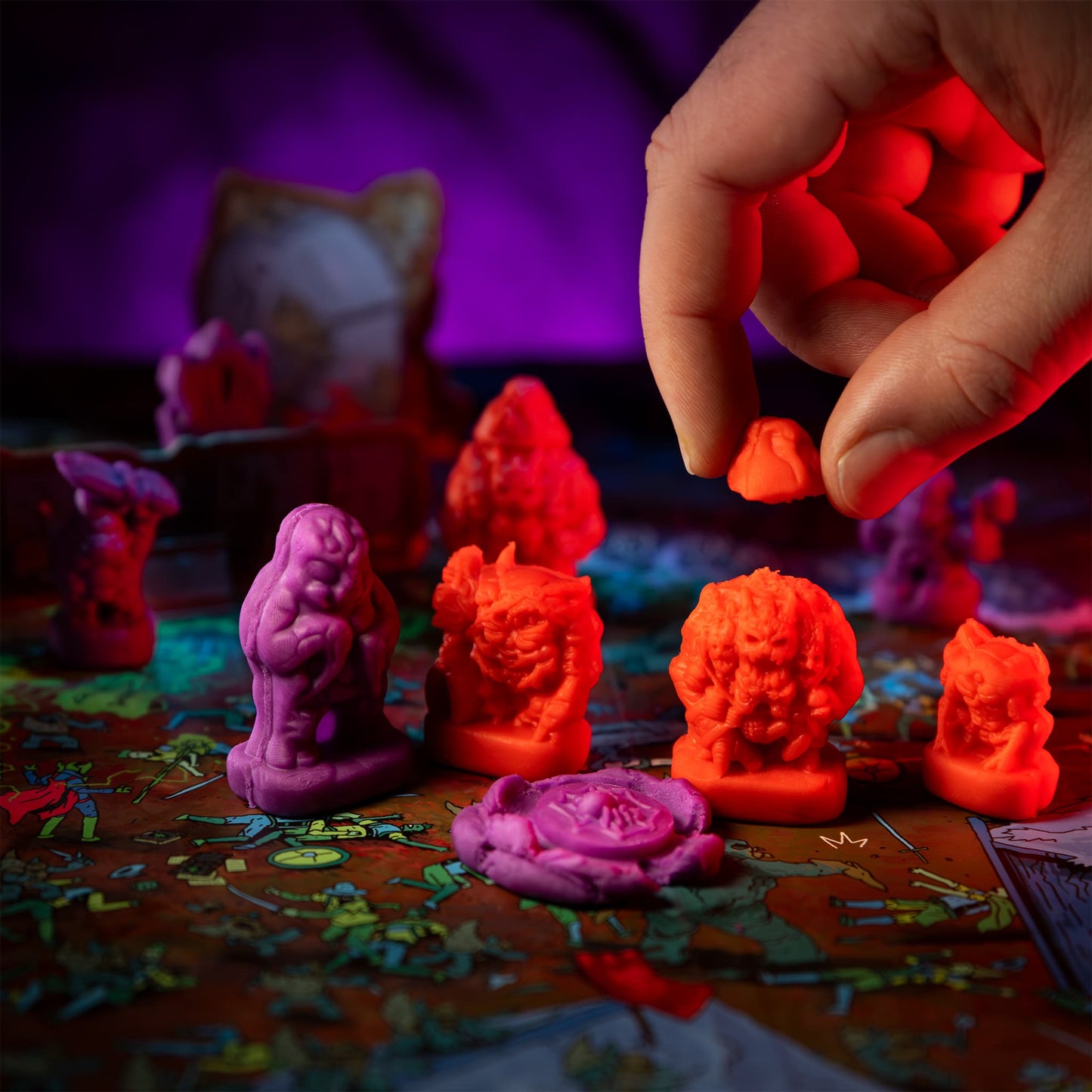 
                  
                    Player twisting the top off Magmass clay mini (compare to play dough) in a Necromolds wargame
                  
                