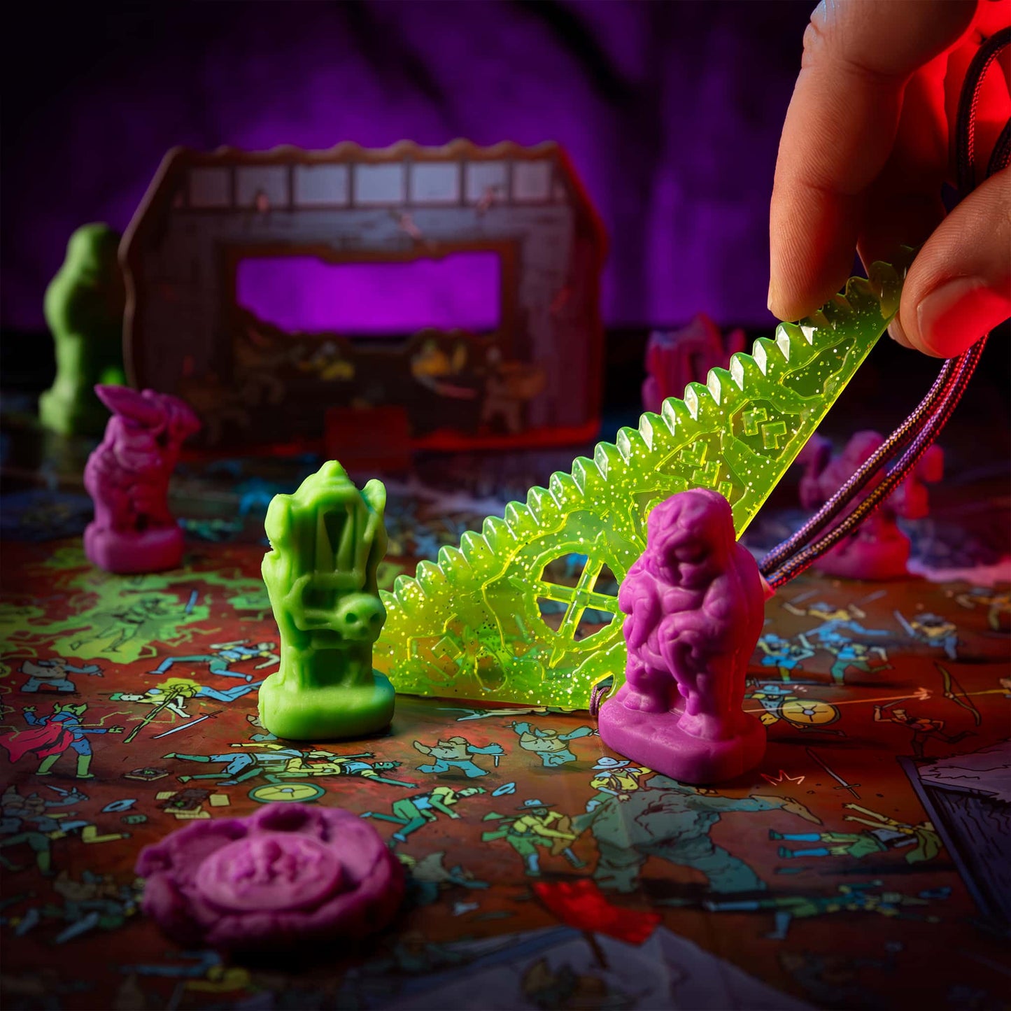 
                  
                    Clay minis of creepy monsters created from clay molds being used in the Necromolds wargame board game. The clay is similar to play doh. The player is measuring the distance between two minis.
                  
                
