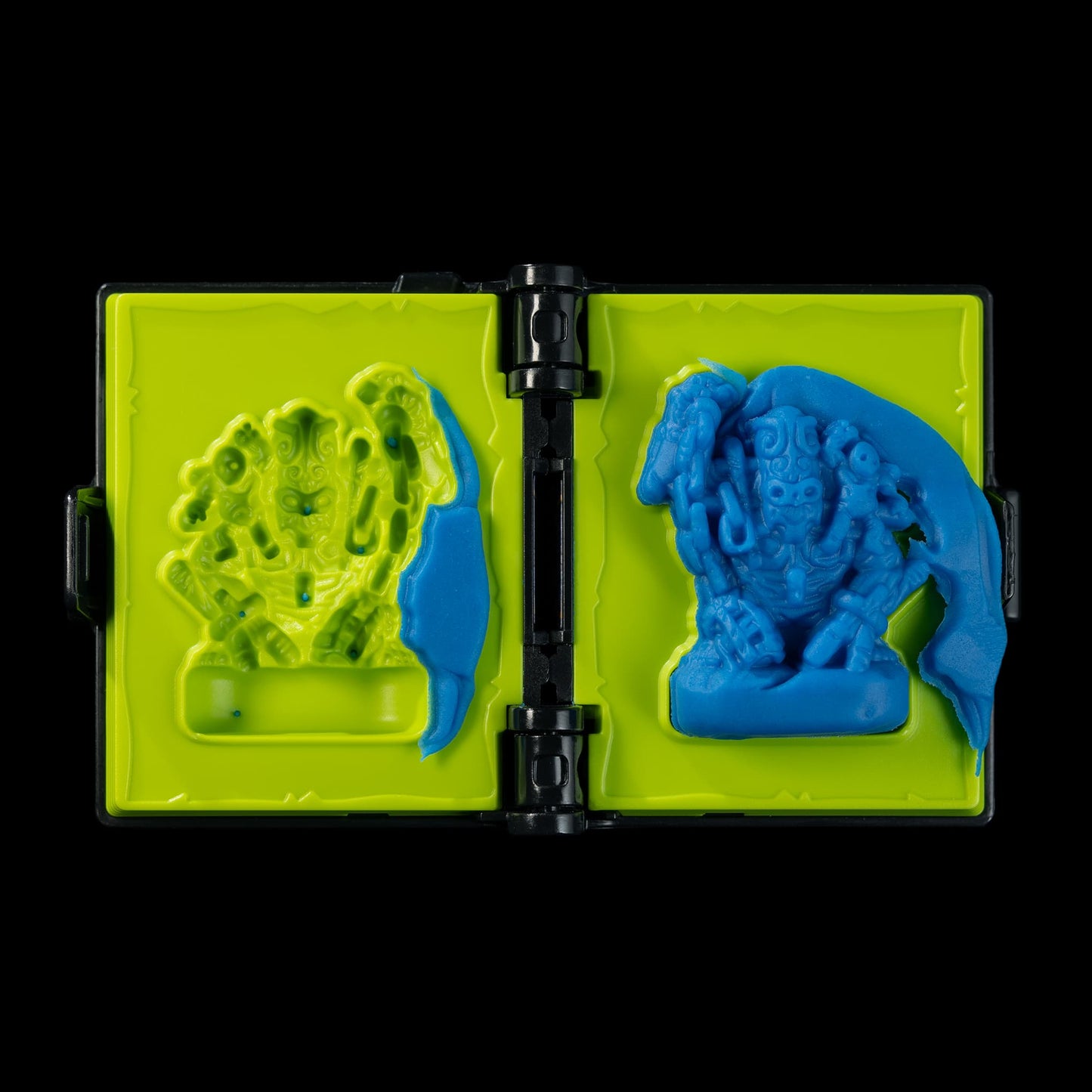 
                  
                    A spellbook shaped clay mold toy used in the Necromolds wargame to mold clay minis in the shape of creepy monsters. The clay is similar to blue play doh.
                  
                